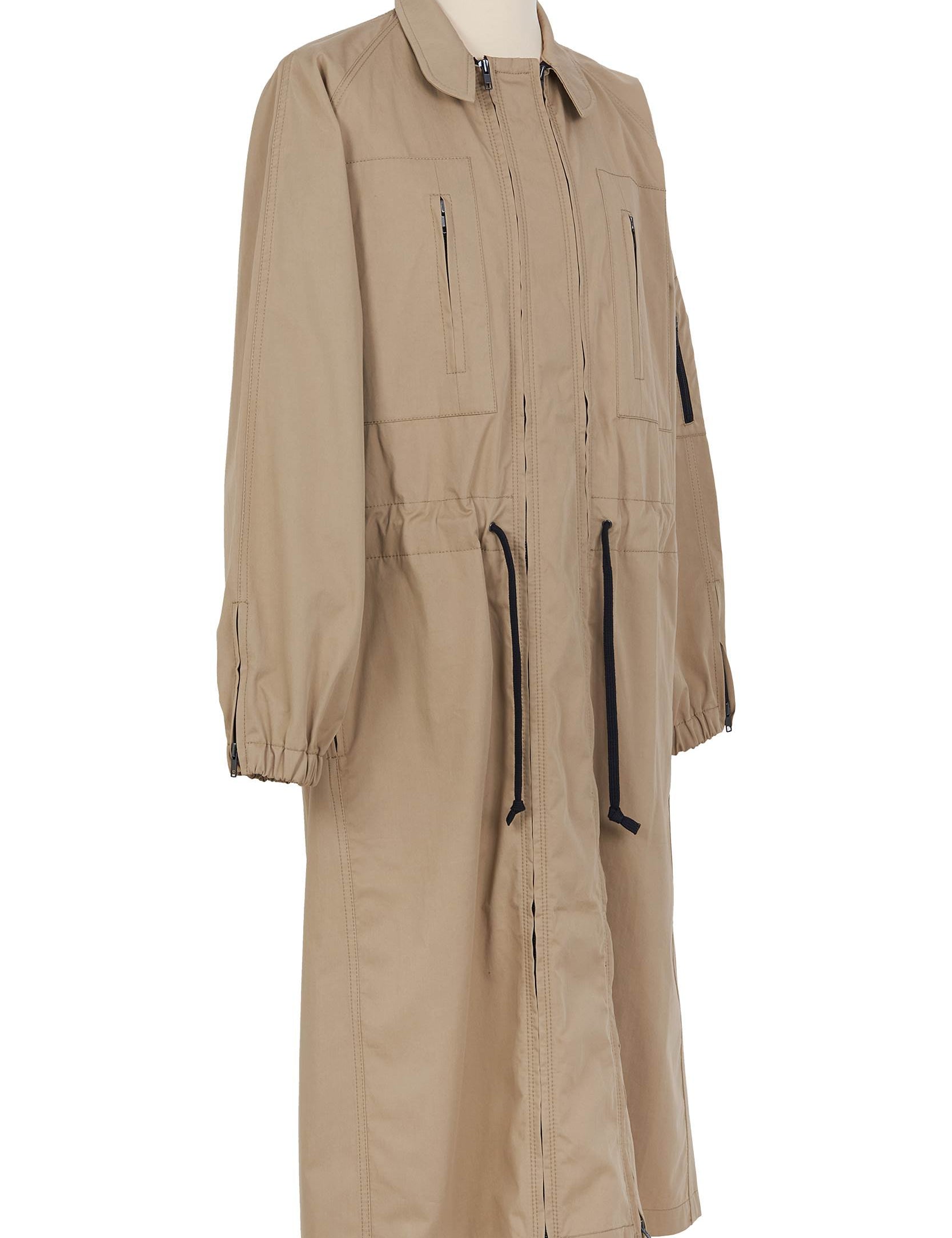Beige cotton gabardine coat. spread collar, zip chest and waist pockets, upper‑sleeve zip pocket
