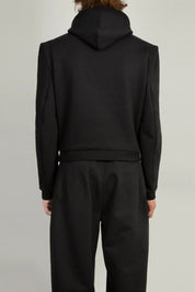 Detail shot of darted sleevehead and defined shoulder on the Random Identities Constructed Shoulder Hoody, Black