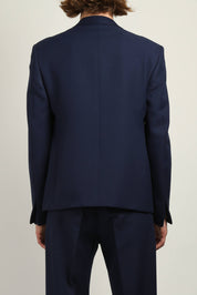 Back view of Navy gaberdine buttonless blazer by Random Identities highlighting clean tailored silhouette