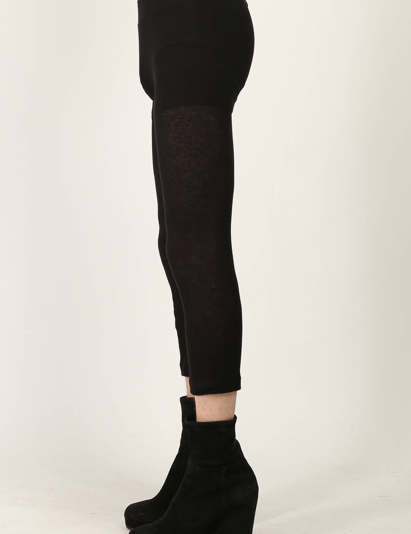 Black fine ribbed jersey leggings by Random Identities featuring split cuff and press button detail, styled with minimalist top