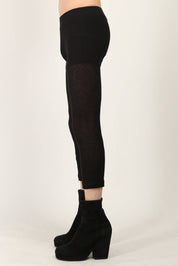 Black fine ribbed jersey leggings by Random Identities featuring split cuff and press button detail, styled with minimalist top