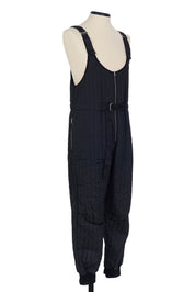 Black quilted salopette by Random Identities. adjustable length detail, 100% polyester