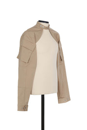 Beige cotton shrug jacket by Random Identities. front view with press buttons