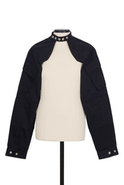Random Identities Shrug Jacket in Black. collarless with press-button fastening and sleeve cargo pocket