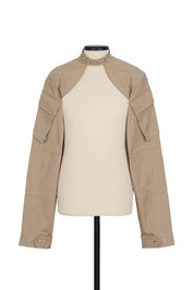 Random Identities Shrug Jacket in Beige. collarless with press-button fastening and sleeve cargo pocket