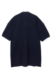 Navy piqué maxi polo by Random Identities. covered zip placket, flat-knit collar