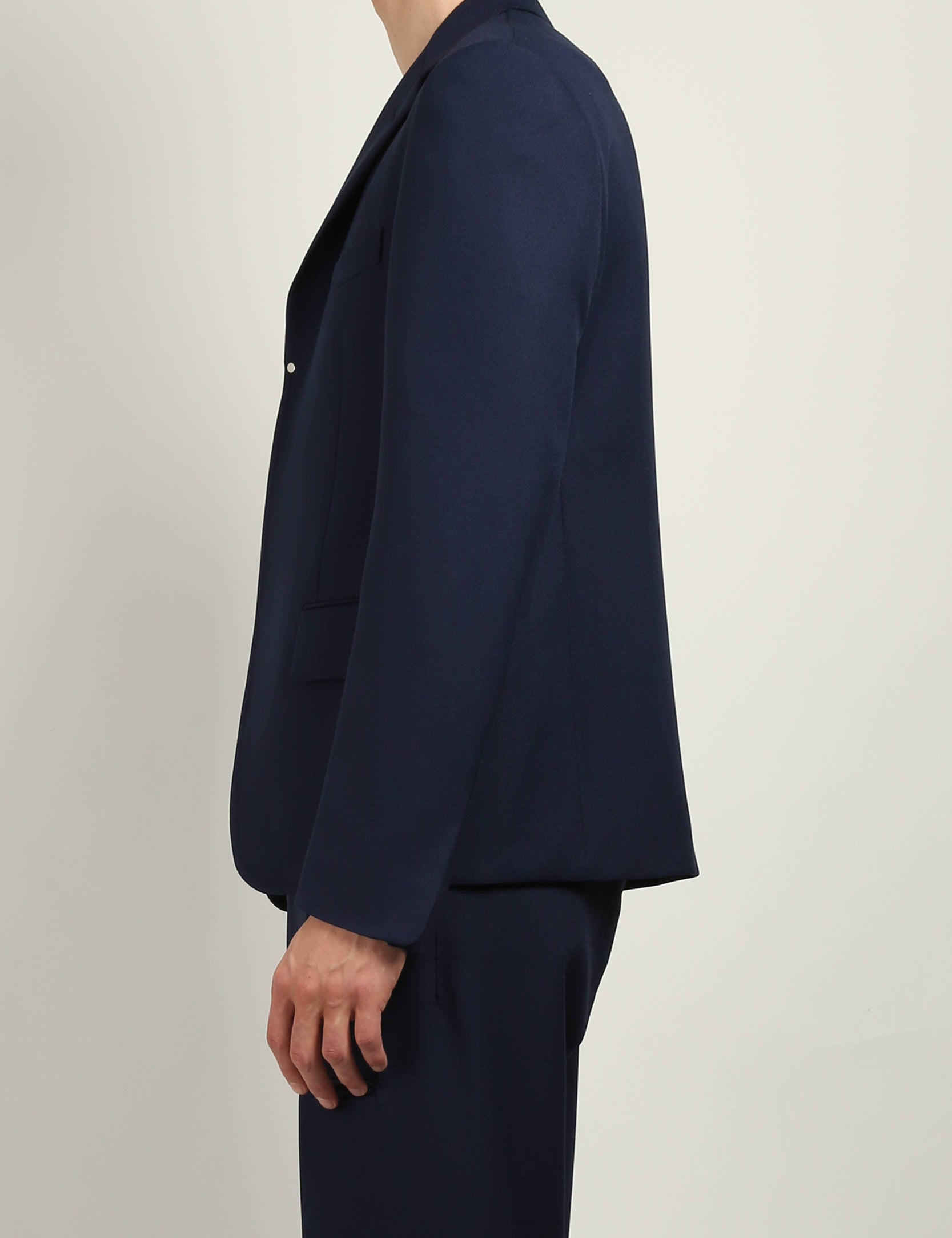 Navy Buttonless Blazer by Random Identities worn open, showing gaberdine fabric, notch lapel, and curved cuff hem