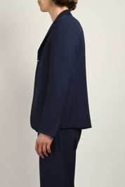 Navy Buttonless Blazer by Random Identities worn open, showing gaberdine fabric, notch lapel, and curved cuff hem