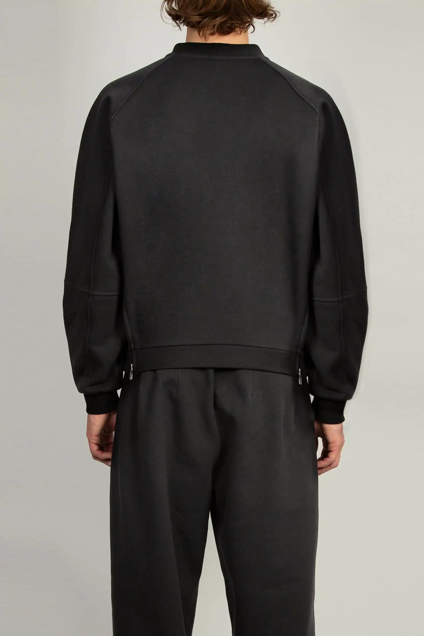 Unisex black jersey sweatshirt featuring raglan sleeves