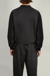 Unisex black jersey sweatshirt featuring raglan sleeves