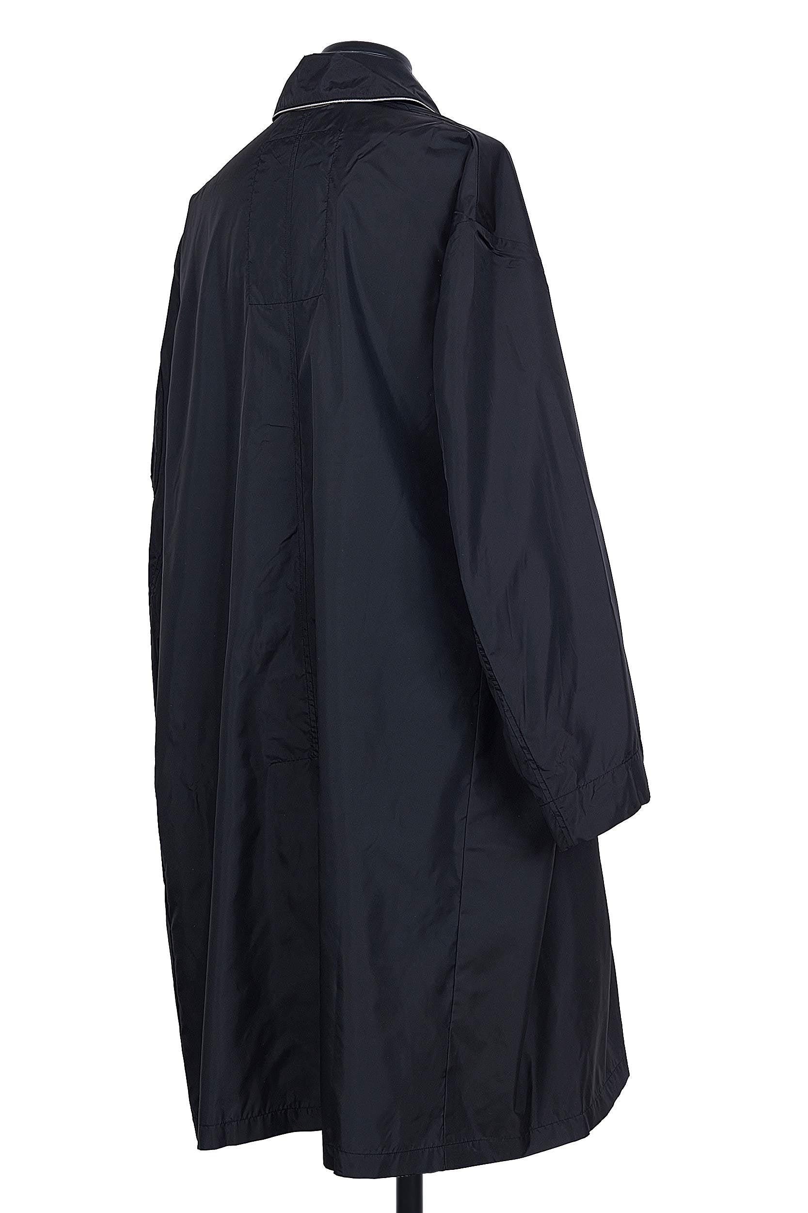 Random Identities Black raincoat featuring diagonal self‑fabric strap and contrast piping