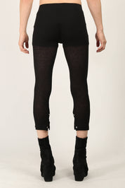 Back view of Black Rib Leggings by Random Identities showing slim silhouette and split cuff detail