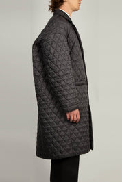 Black single breasted coat with front welt pockets and rounded back profile