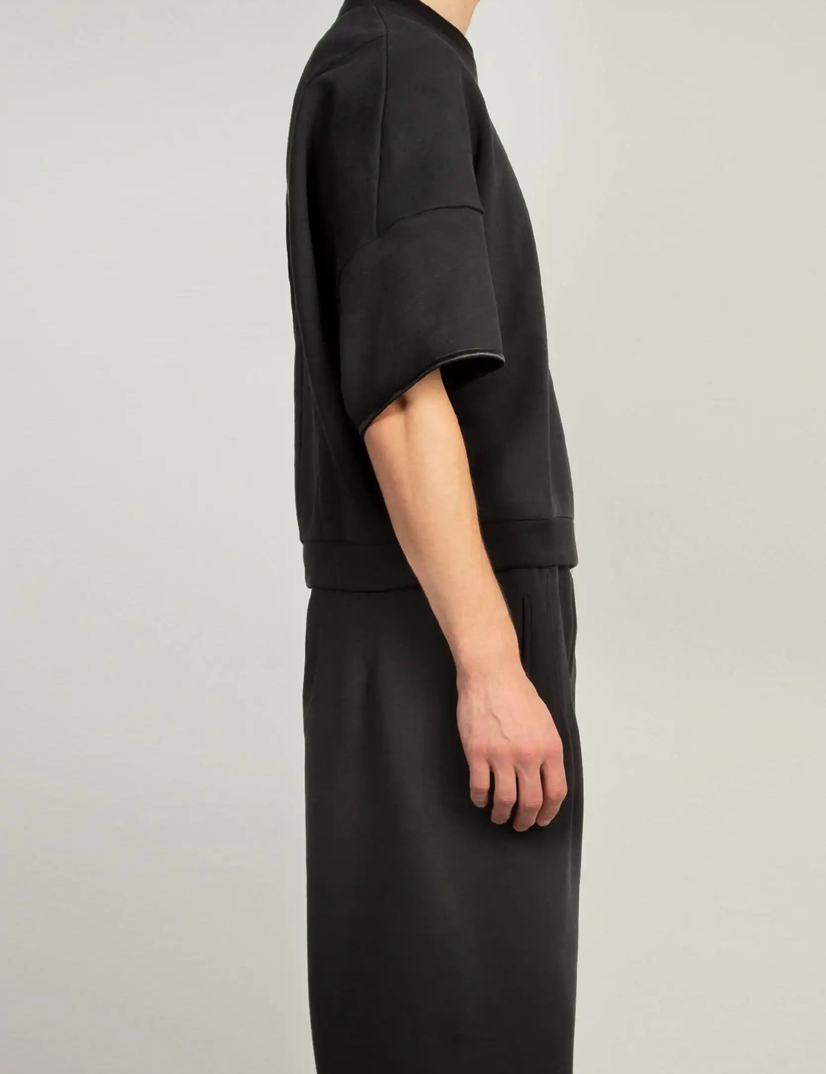 Side view of Black crew neck short sleeve sweatshirt with elasticated sleeve hem and emphasised back by Random Identities