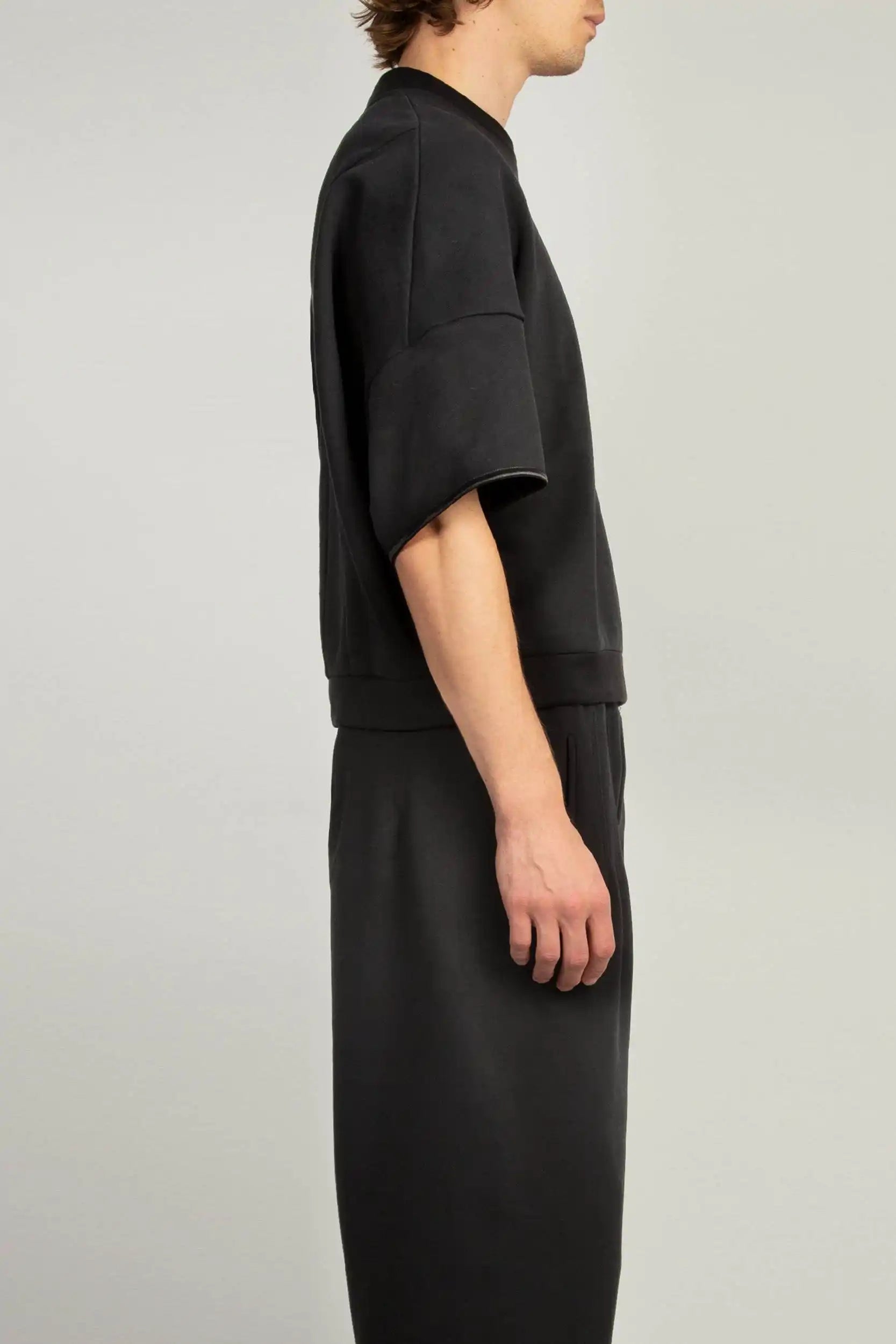 Side view of Black crew neck short sleeve sweatshirt with elasticated sleeve hem and emphasised back by Random Identities