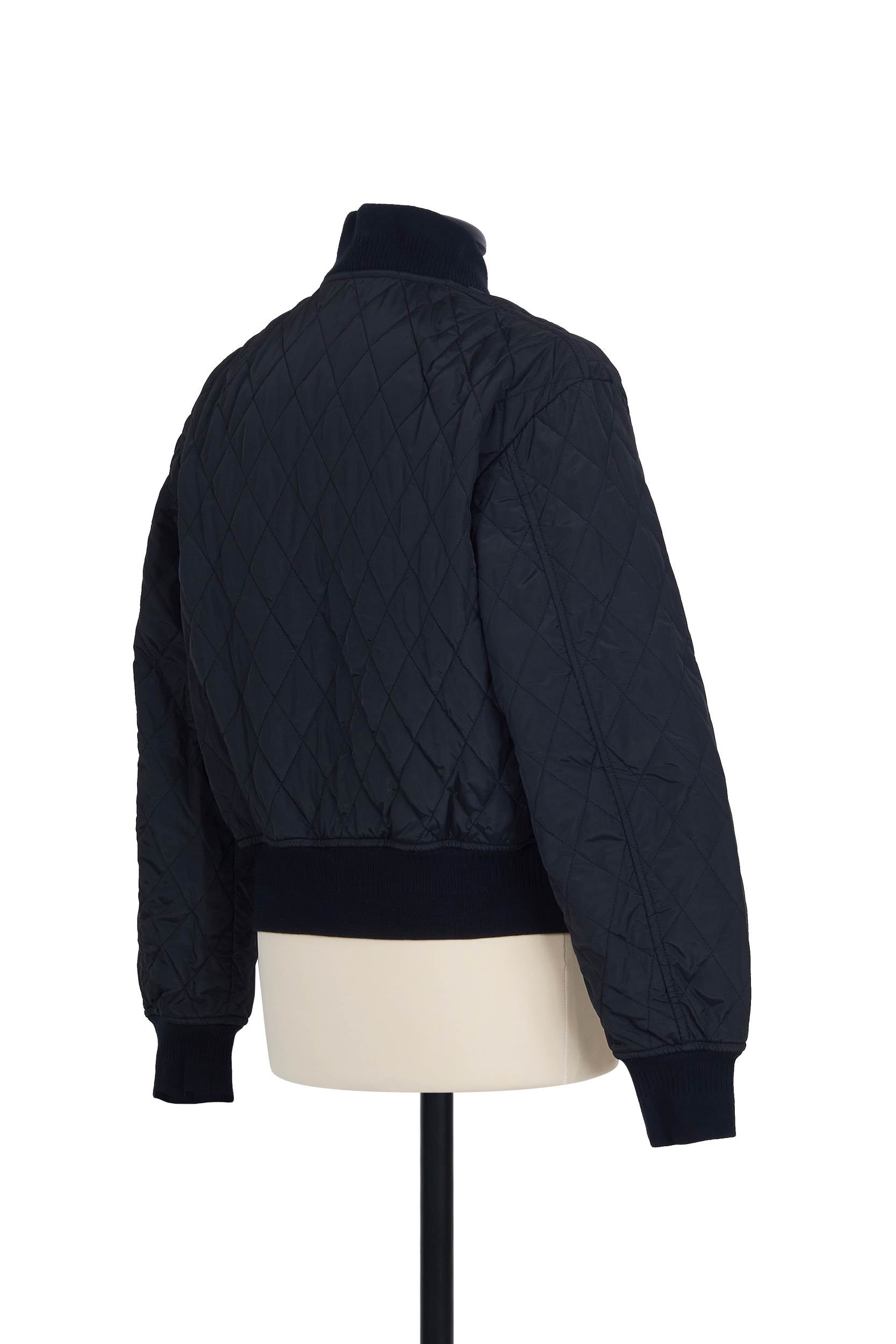 Quilted Bomber in Black. 100% polyester, regular fit, ribbed finishings