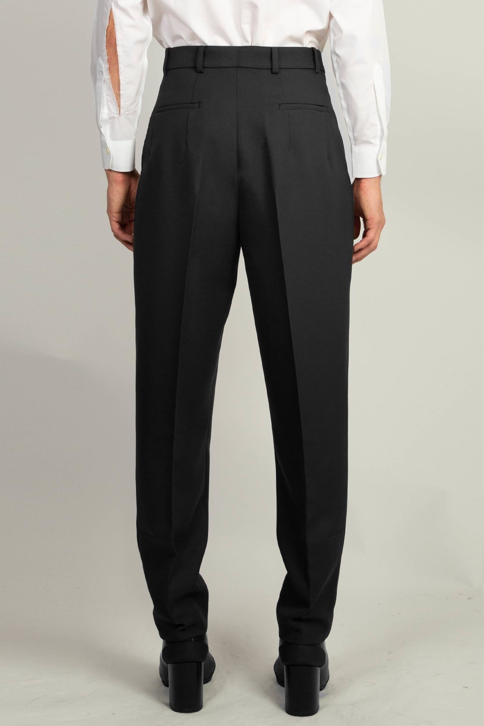 back view of Black Pleated Tapered Trouser by Random Identities showing tapered leg and clean tailored lines