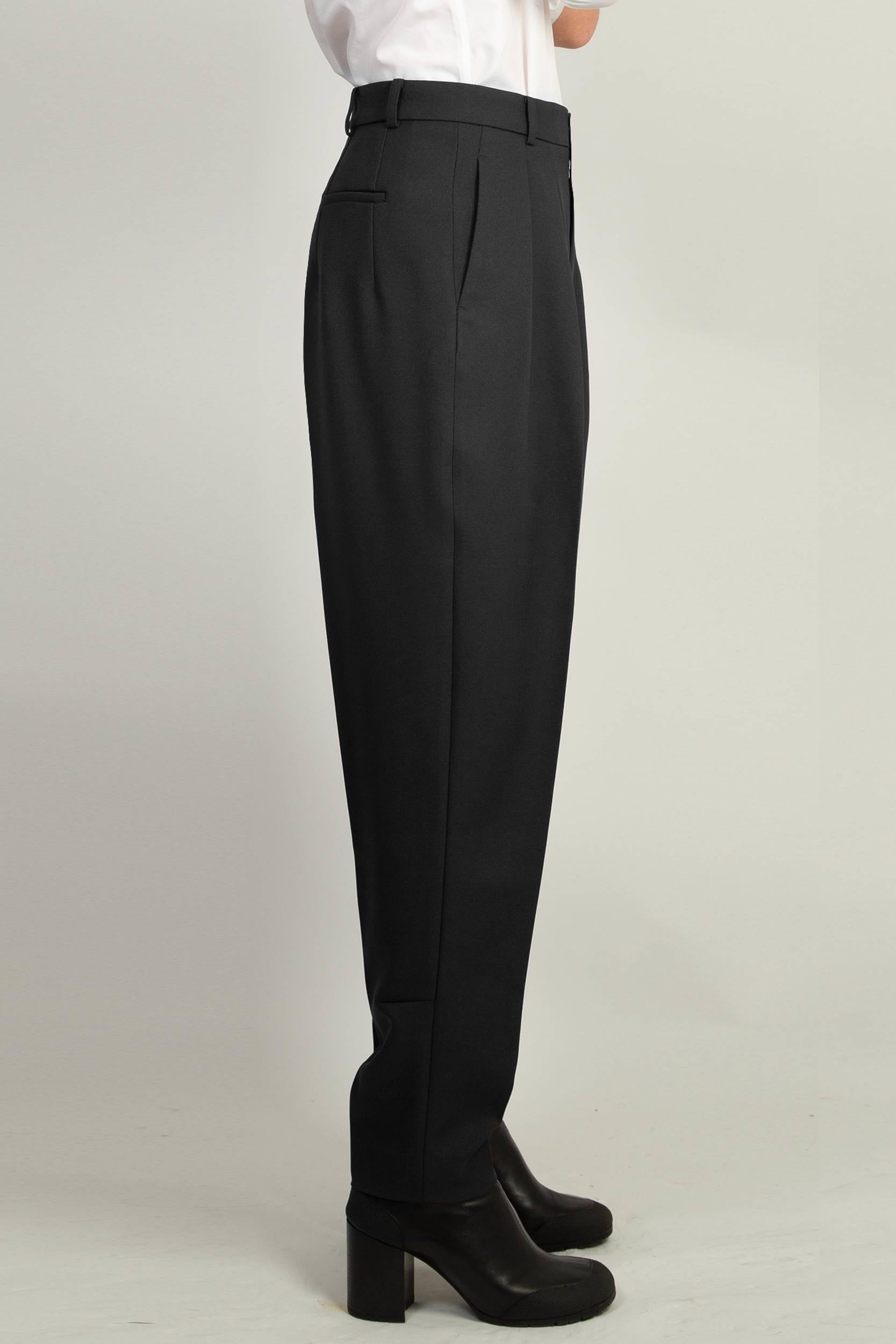 Black Pleated Tapered Trouser by Random Identities styled with buttonless blazer, tapered leg silhouette