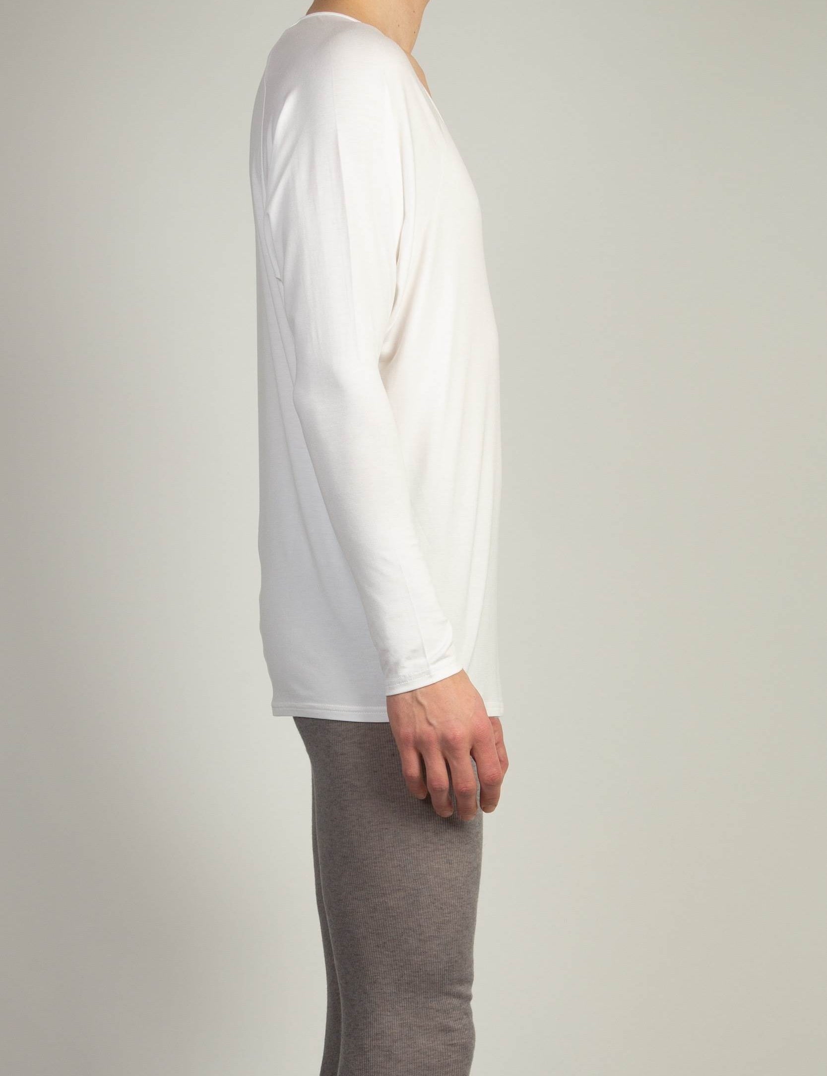 White Drapey V-Neck top by Random Identities in soft jersey with wide curved V-neckline, styled with tailored trousers
