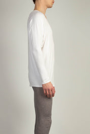White Drapey V-Neck top by Random Identities in soft jersey with wide curved V-neckline, styled with tailored trousers